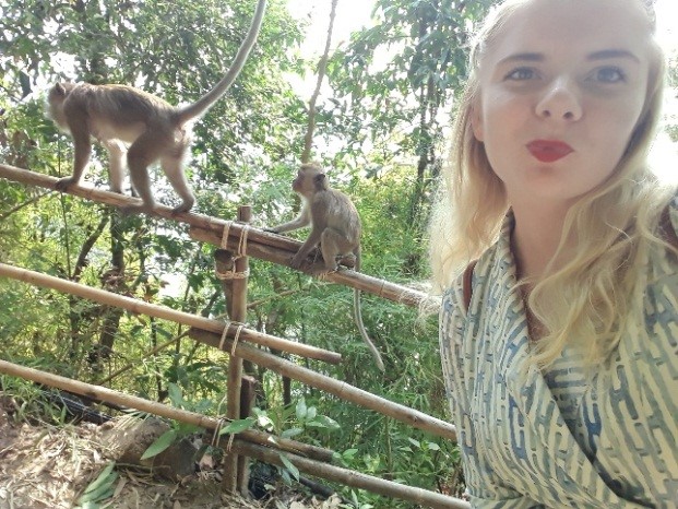 Marika Varga walking past monkeys on her way to work at her placement year in Thailand