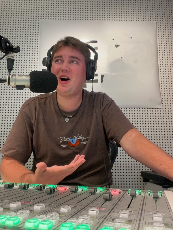 Intern Elliott Wallace presenting a radio show in the studio in Sydney, Australia